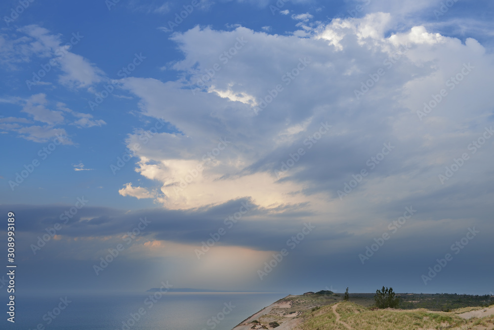 Landscape near sunset of sand dune, sunbeams and waters of Lake Michigan, Sleeping Bear Dunes National Lakeshore, Michigan, USA 