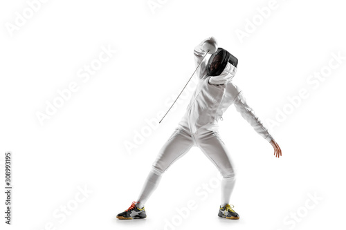 Teen girl in fencing costume with sword in hand isolated on white studio background. Young female caucasian model practicing and training in motion, action. Copyspace. Sport, youth, healthy lifestyle.