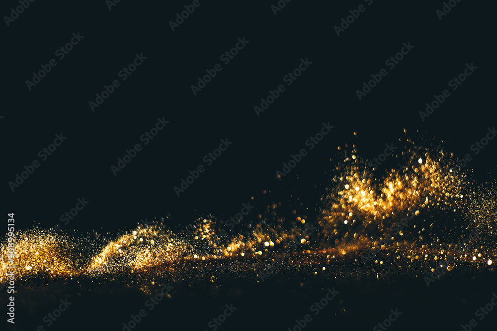 Obraz premium Golden overlay background of golden lights with bokeh effect. Includes copy space