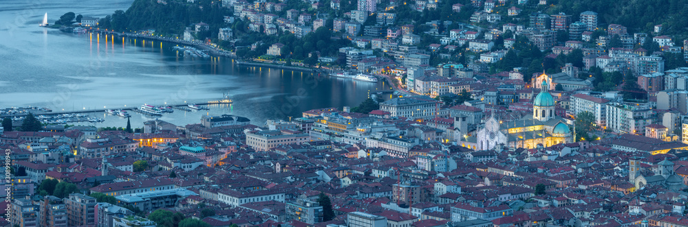 Como - The panorama of the city with the Cathedral and lake Como at dusk.