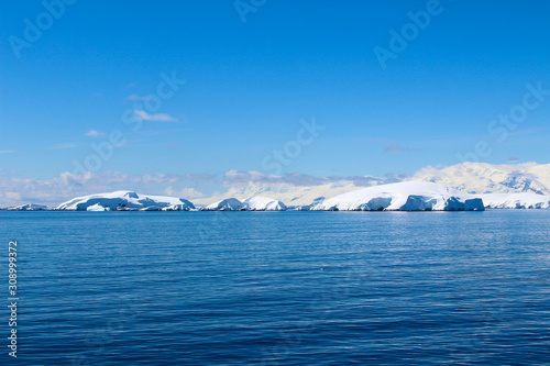 Snow-capped mountains on an island along the coasts of the Antarctic Peninsula  Antarctica