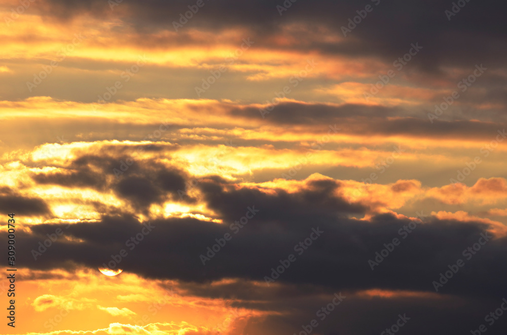 Sunset. Sky with clouds illuminated by sunlight.Background.