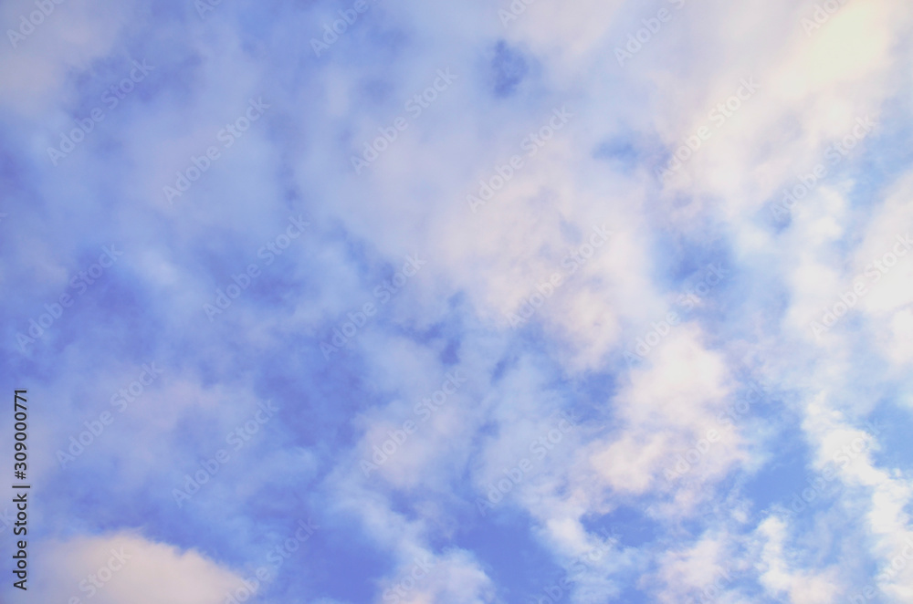 Blue sky with white small clouds. Background and texture.