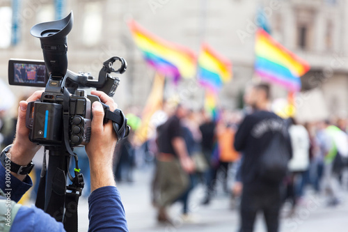 Camera operator recording LGBT parade or Gay pride