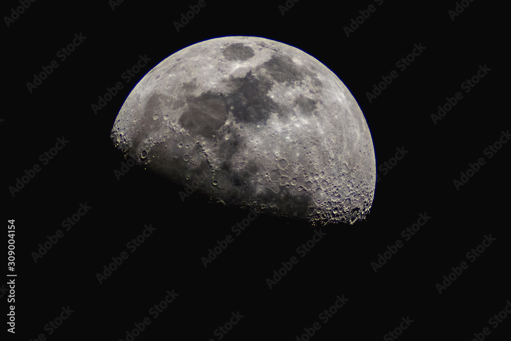 Surface of the Moon on black background, close up.