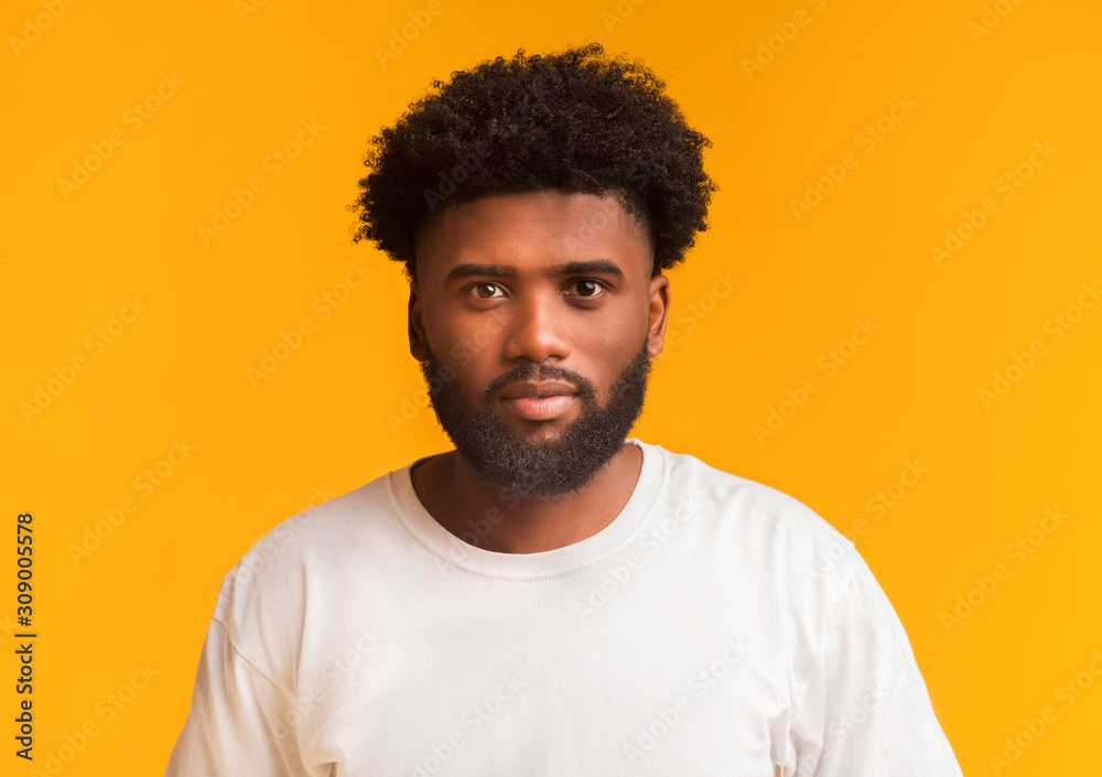 Young handsome black guy over orange background Young handsome black guy over orange background