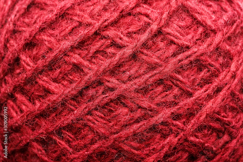 Wool yarn close-up colorful red thread for needlework in macro.