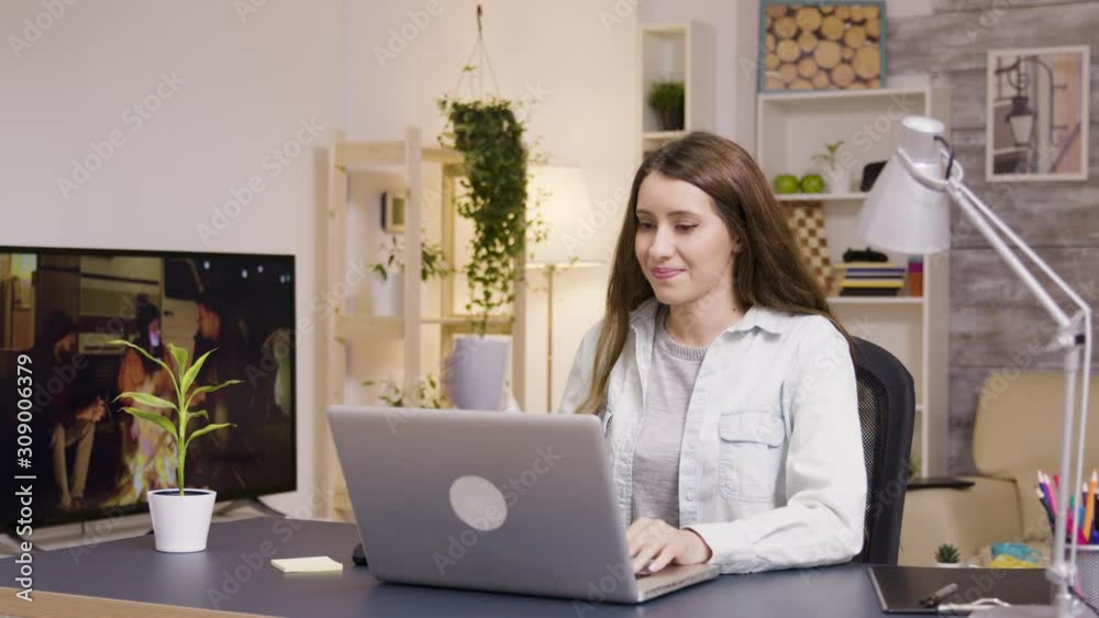 Girl drinking coffee while working on laptop from home Girl drinking coffee while working on laptop from home