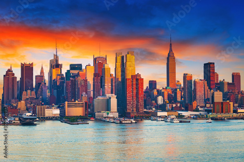 Manhattan skyline illuminated by sunset © sborisov