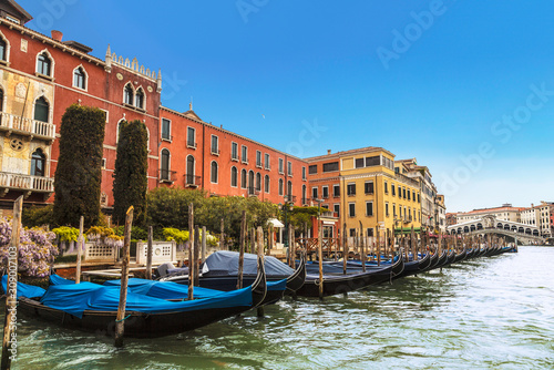 View of the Grand canal, pier with gondolas and Rialto bridge on the horizon, Venice, Italy © vesta48
