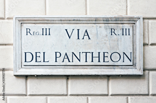 Typical marble street name sign on building wall in Rome, Italy