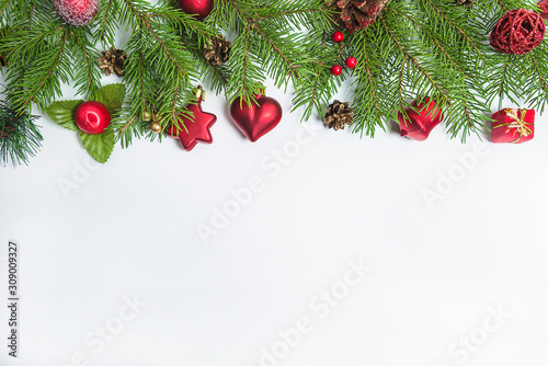 Christmas holiday background with fir branches and christmas decorations on the white background. Copy space