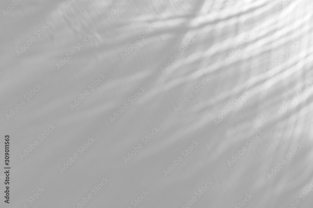 Obraz premium Water texture overlay effect for photo and mockups. Organic drop diagonal shadow and light caustic effect on a white wall. 