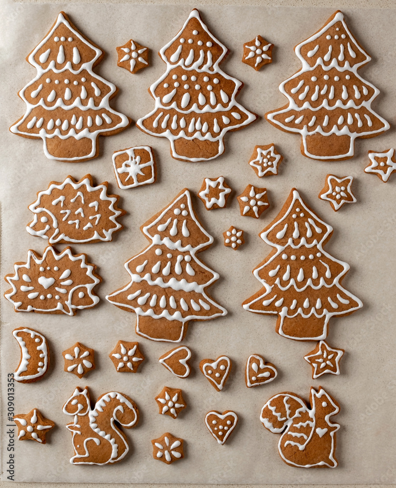 Christmas gingerbread cookies on parchment paper Christmas gingerbread cookies on parchment paper