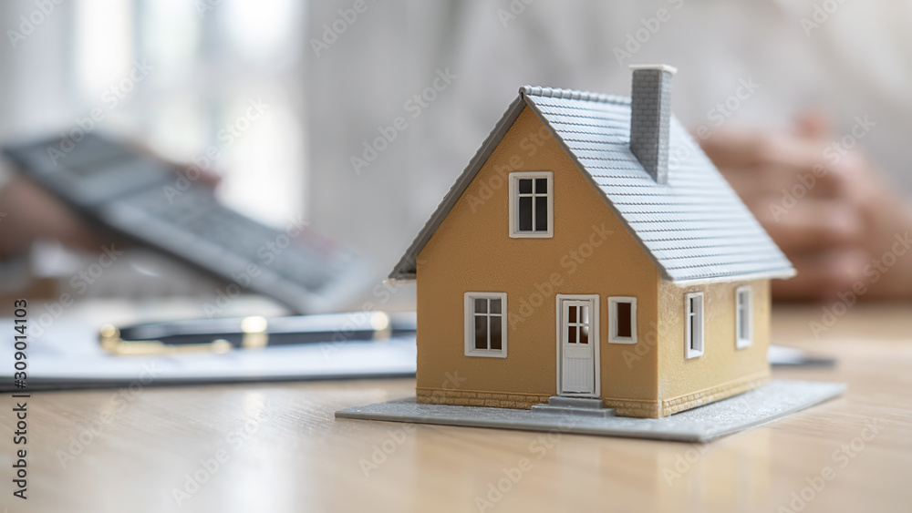 House model with agent and customer discussing for contract to buy, get insurance or loan real estate or property. House model with agent and customer discussing for contract to buy, get insurance or loan real estate or property.