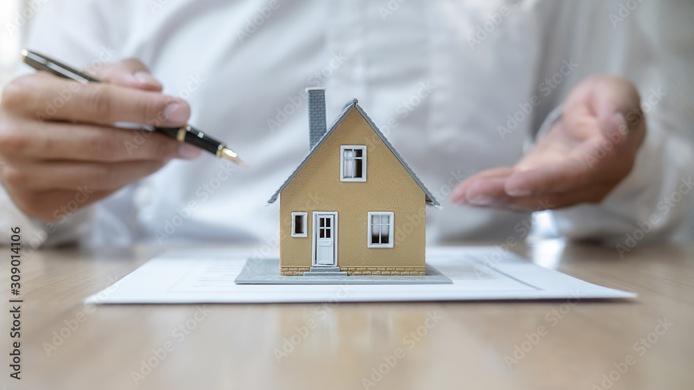 House model with agent asking costumer for contract to buy, get insurance or loan real estate or property. House model with agent asking costumer for contract to buy, get insurance or loan real estate or property.