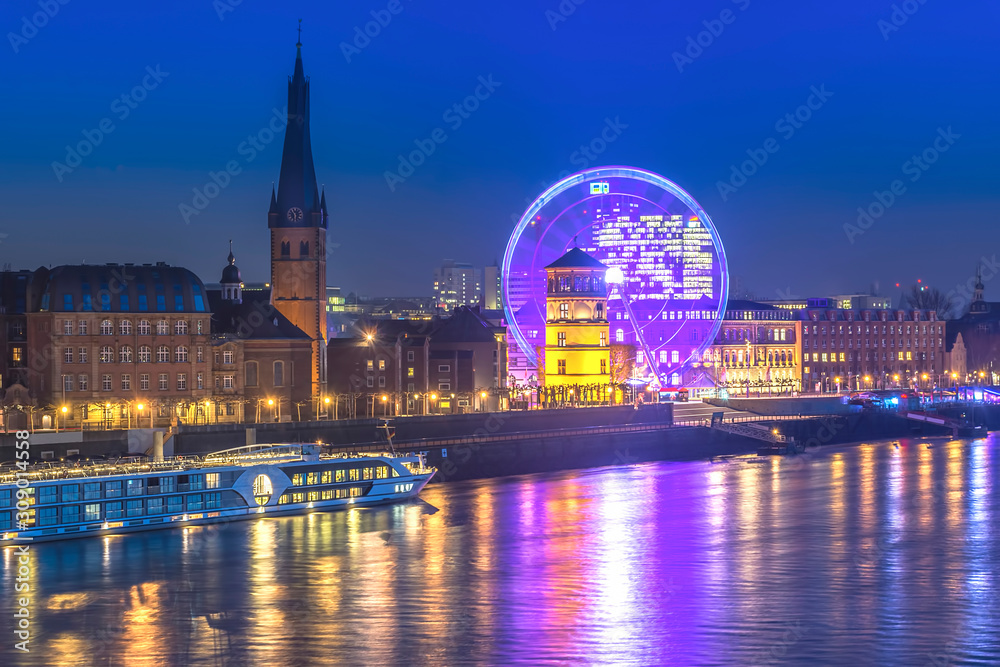 Düsseldorf rhine front with Old Town, Schlossturm musuem and ferris wheel during night 