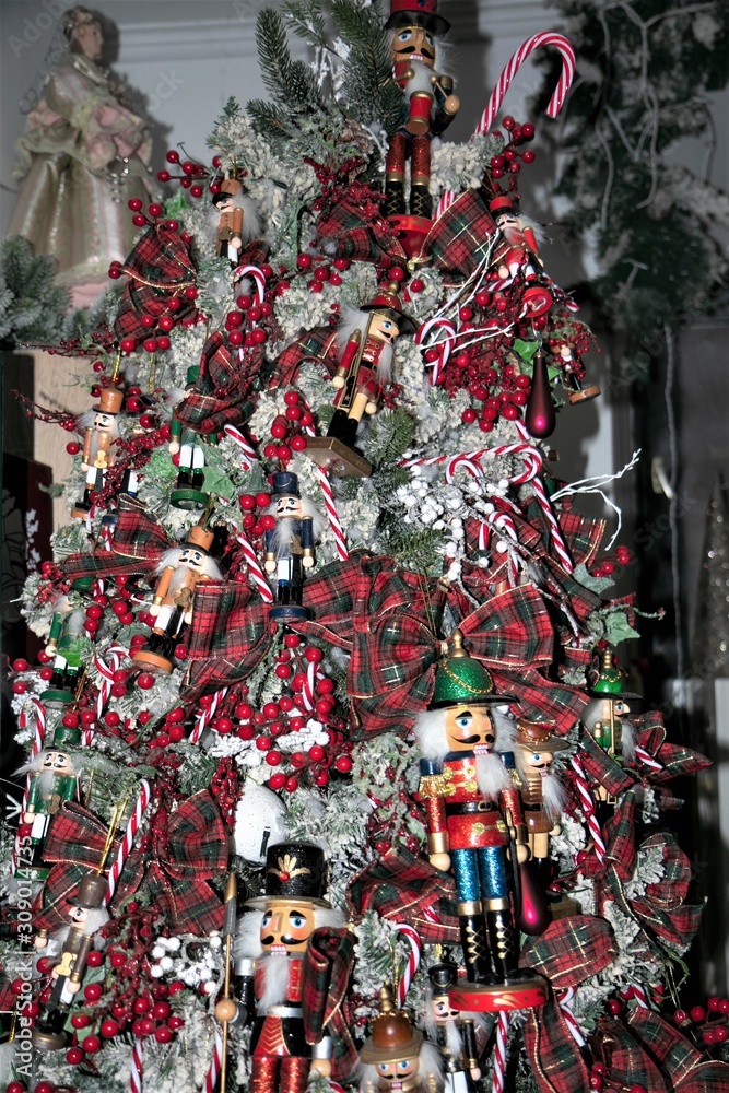 festively decorated christmas tree with checked grinds and nutcracker