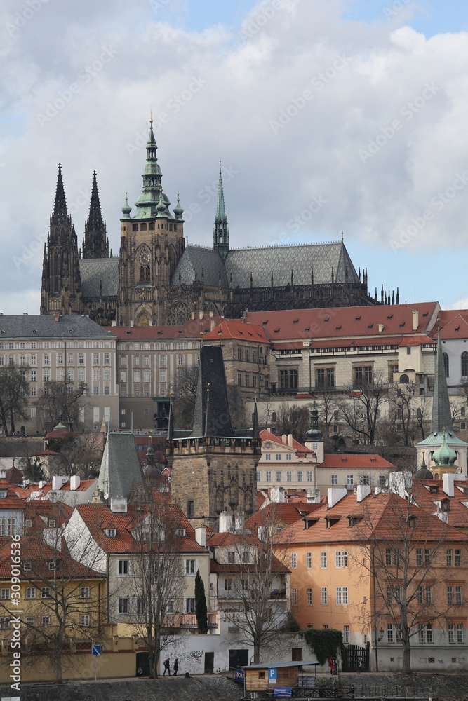 A cityscape view of Prague and the castle overlooking the town A cityscape view of Prague and the castle overlooking the town
