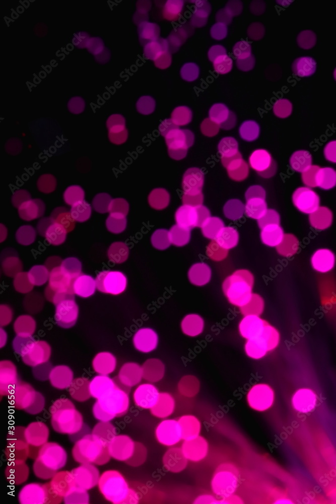 New Year and Christmas color illumination. The illusion of a salute explosion. The quirks of light fiber optic lamp. Blurry circles, bokeh on a dark background. Big explosion. New Year and Christmas color illumination. The illusion of a salute explosion. The quirks of light fiber optic lamp. Blurry circles, bokeh on a dark background. Big explosion.