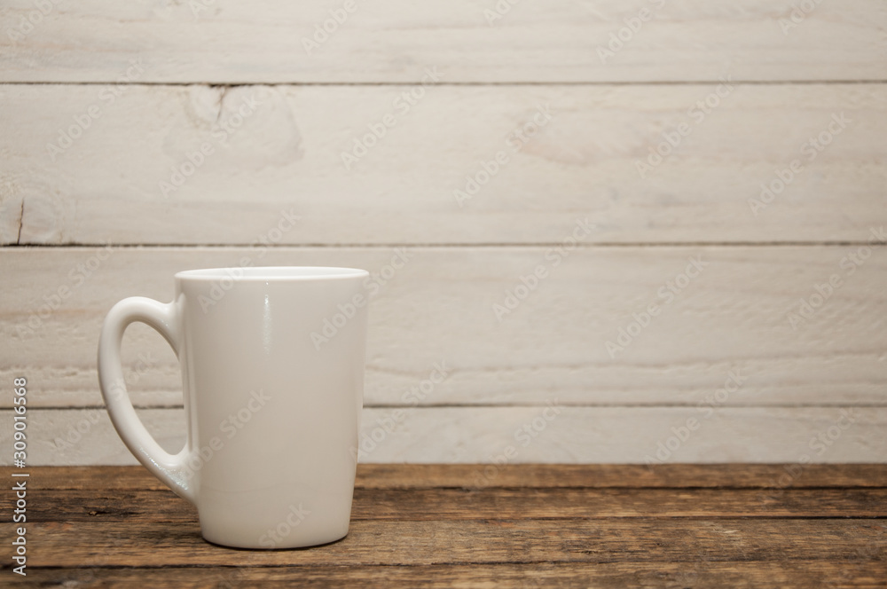 White cups stand on a wooden table. Wood texture. White cups stand on a wooden table. Wood texture.