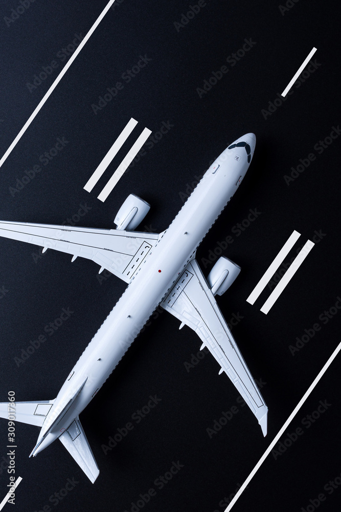 Aircraft ready for take off. Airplane model on runway viewed from above. Travel concept, flight tickets booking Aircraft ready for take off. Airplane model on runway viewed from above. Travel concept, flight tickets booking