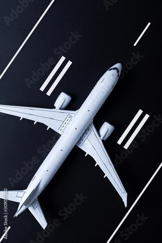 Aircraft ready for take off. Airplane model on runway viewed from above. Travel concept, flight tickets booking