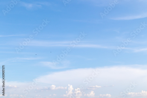 Beautiful blue clear sky with white clouds background in sunny day and copy space. Nature bright sky background image. Summer blue sky. Texture for Design. Natural cloudy Wallpaper.