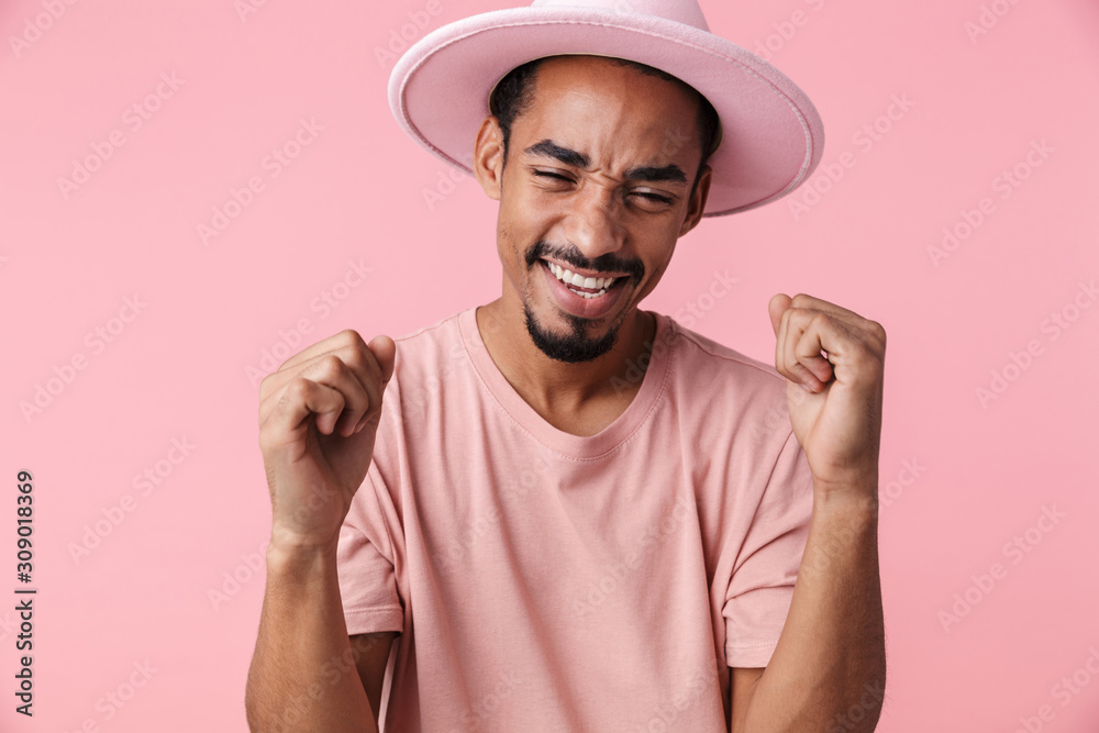 Photo of happy african american man making winner gesture and smiling Photo of happy african american man making winner gesture and smiling