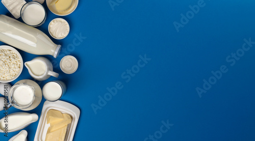 Fotografie Dairy products on blue wooden background, top view