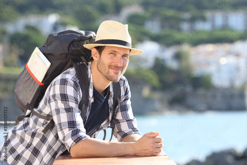 Relaxed tourist looking at camera on vacation