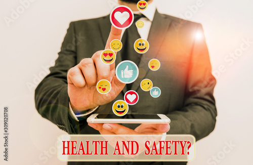 Writing note showing Health And Safety Question. Business concept for regulations and procedures to prevent accident or injury