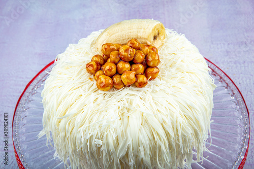 Banana cake (sacakli yas pasta) with white chocolate. on pink wooden background. pastry shop concept. photo