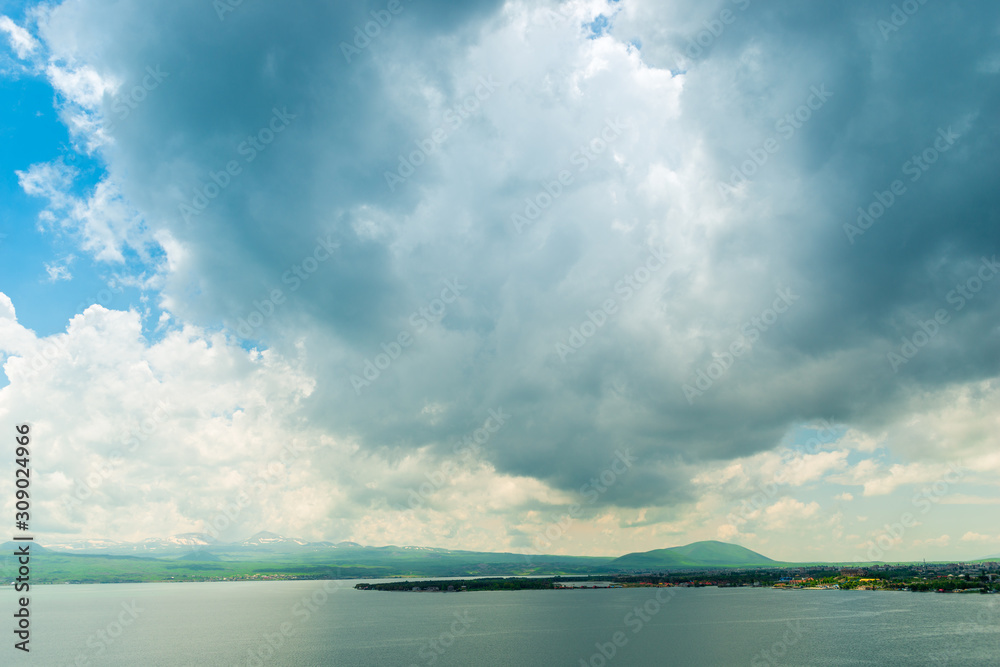 heavy black cloud over the beautiful lake Sevan in Armenia, picturesque summer landscape