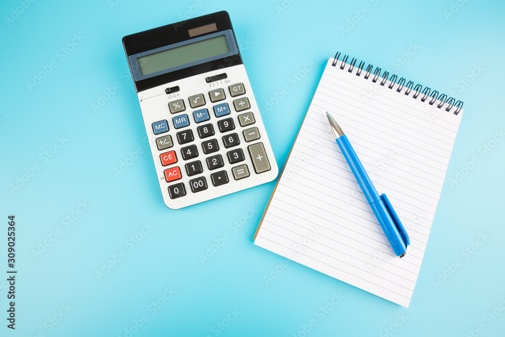 Calculator, blue pen and notepad Calculator, blue pen and notepad