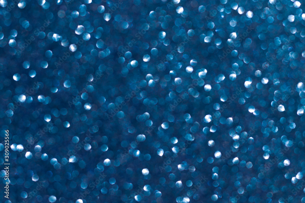 Abstract blue background. Shiny glitter bokeh in blue colors. Classic blue.