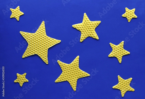blue christmas background with beewax stars