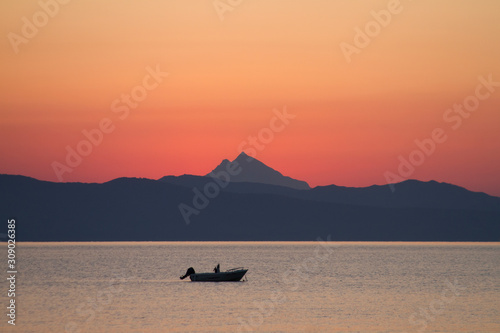 boat at sea at sunrise near Mount Athos, Greece
