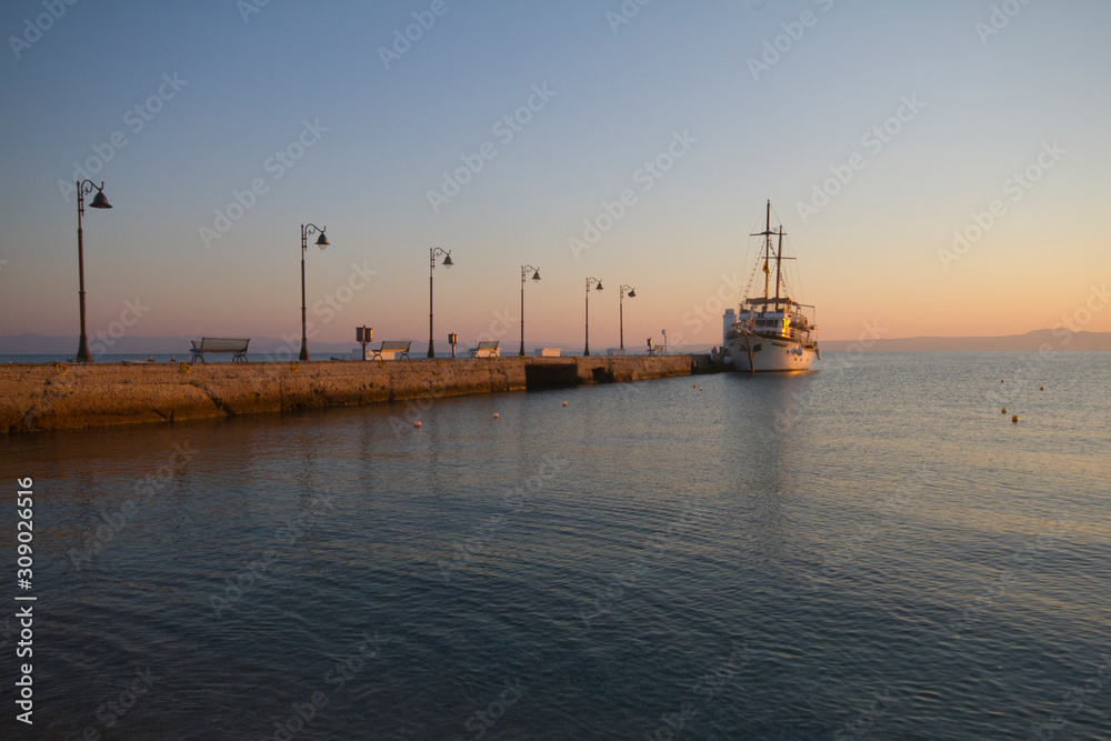 ship at the end of a long dock, Pefkochori, Greece, sunrise