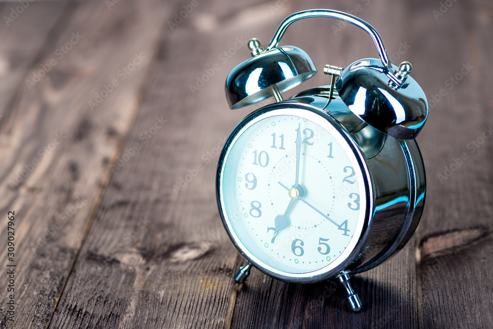 7 hours retro steel alarm clock on wooden boards 7 hours retro steel alarm clock on wooden boards
