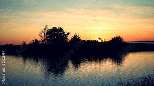 Sunset over Assateague Island over marshes, salt water bay with silhouette © JMP Traveler