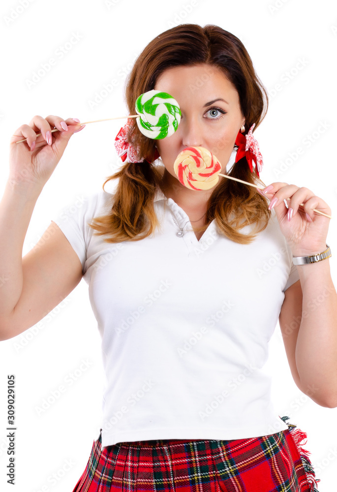 Portrait of a young woman who closed her eyes with candy caramel on a white background.