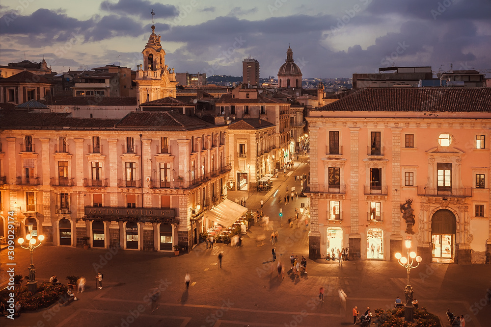Obraz premium Streets of night city with some people walking around shops, palaces, local cafes, Catania. Sicily.