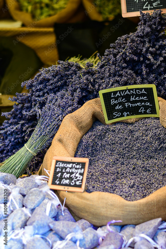 Fototapeta premium farmers market for spices, aromatic herbs and dried fruits in Italy. the names of herbs and spices in Italian and the price in euros are written on black plates