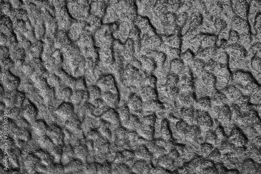 The rough surface of metal plate, a fragment of a cast iron stove .Close up. The rough surface of metal plate, a fragment of a cast iron stove .Close up.