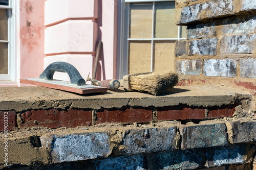 Close up detail of a bricklayer's tools on a construction site in the historic district of Charleston, South Carolina.