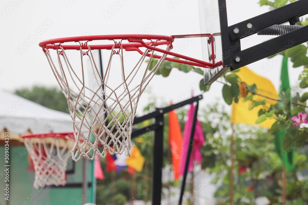 Selective Focus On Basketball Basket And Hoop With Colorful Flags In Blur Background