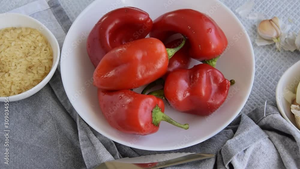 Preparing stuffed red peppers with rice and vegetables. Vegetarian. vegan healthy eating Preparing stuffed red peppers with rice and vegetables. Vegetarian. vegan healthy eating