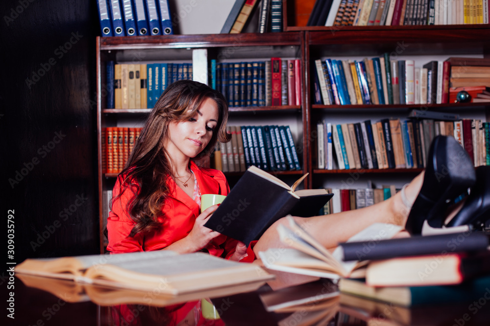 girl is preparing for the exam in the library reads books girl is preparing for the exam in the library reads books