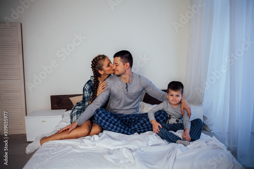 mom dad son in the morning in bed
